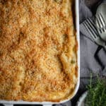 Flat lay of a creamy tuna pasta bake in a white ceramic oven dish.