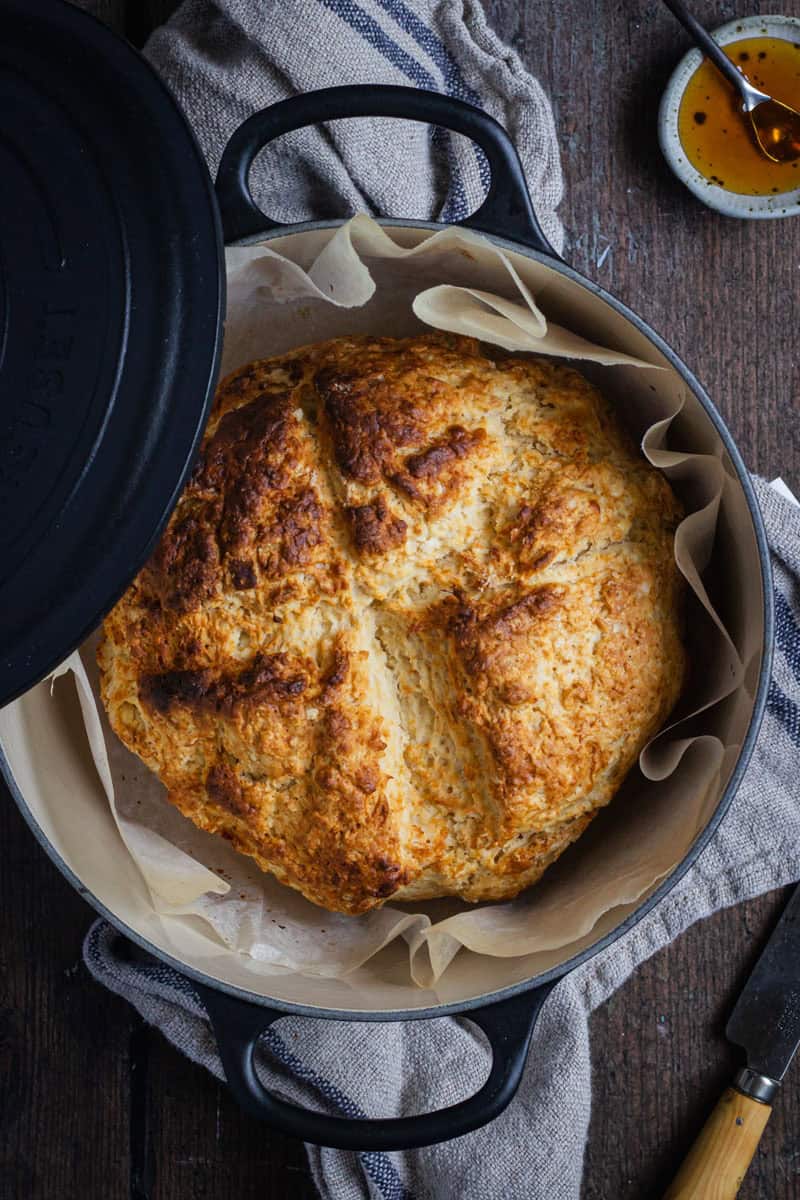 A loaf on damper in a black Le Creuset with the lid sitting on the side like it's just been taken off the pot.