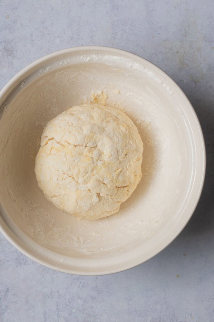 The dough is formed into a ball in the bowl.